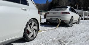 porsche macan with a vw gti hooked on a tow strap