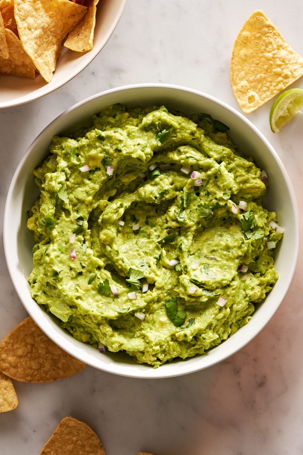 guacamole with diced red onion, cilantro, and with chips