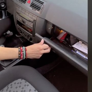 a person's hand on a car seat