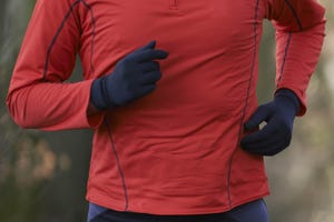 man on winter run through woodland