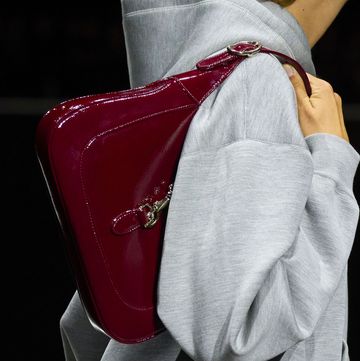a person holding a red purse
