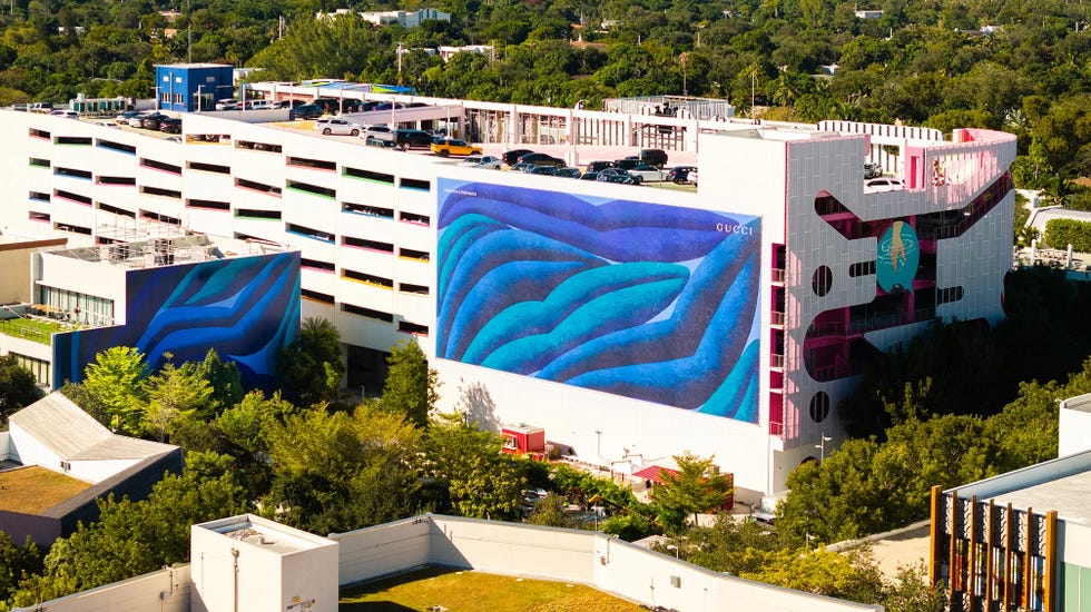 colorful multistory parking structure featuring large murals