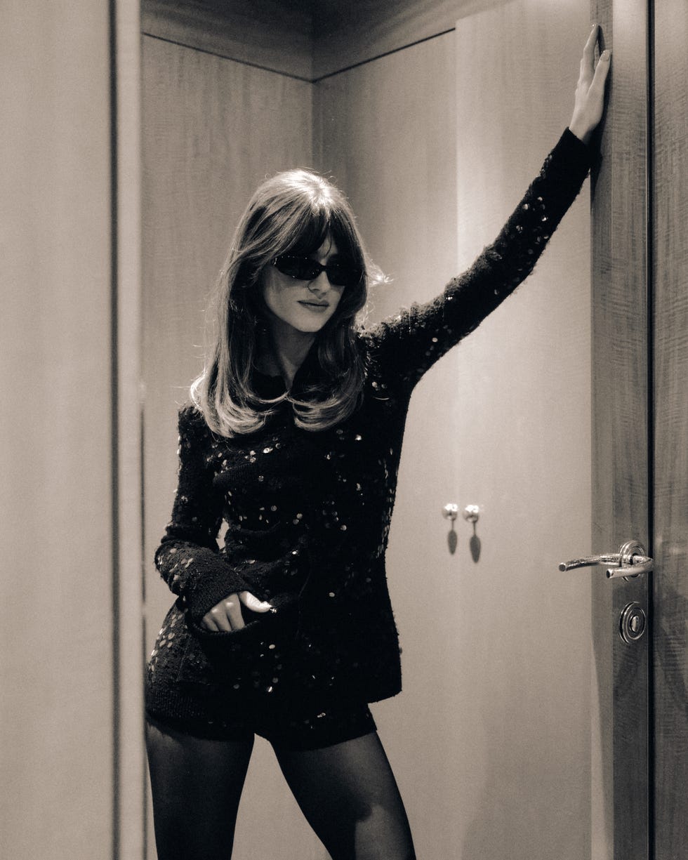 a person posing in an elegant outfit in a stylish interior