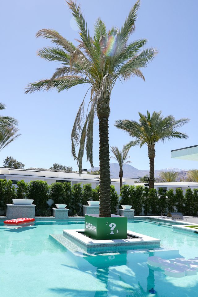 a pool with palm trees and a laptop on it