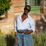a woman at barcelona fashion week wears an oversize button down shirt in a roundup of the best oversize button down shirts of 2022