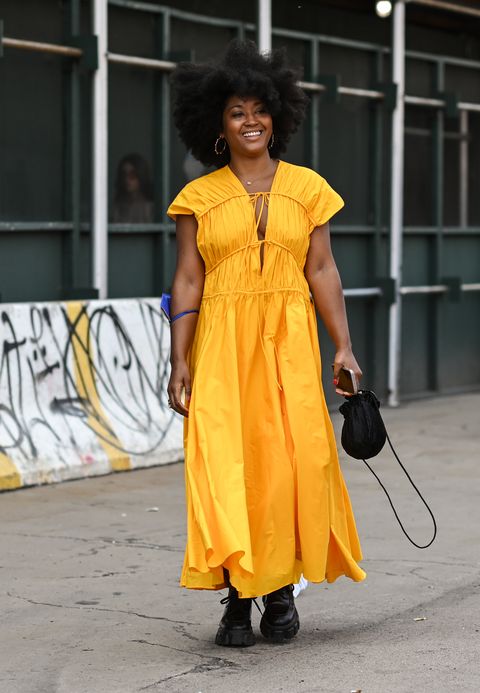 a woman wearing a marigold cotton tie front maxi dress during new york fashion week in a roundup of cute summer outfits 2023