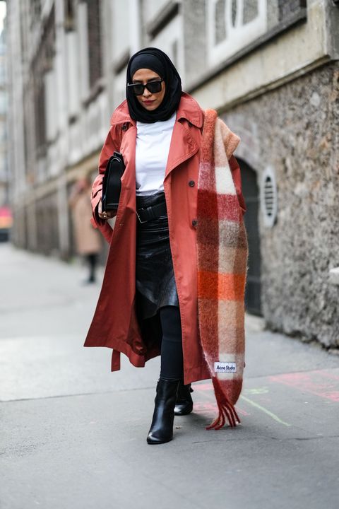 a woman wears an acne studios scarf as part of a story about a viral acne studios scarf