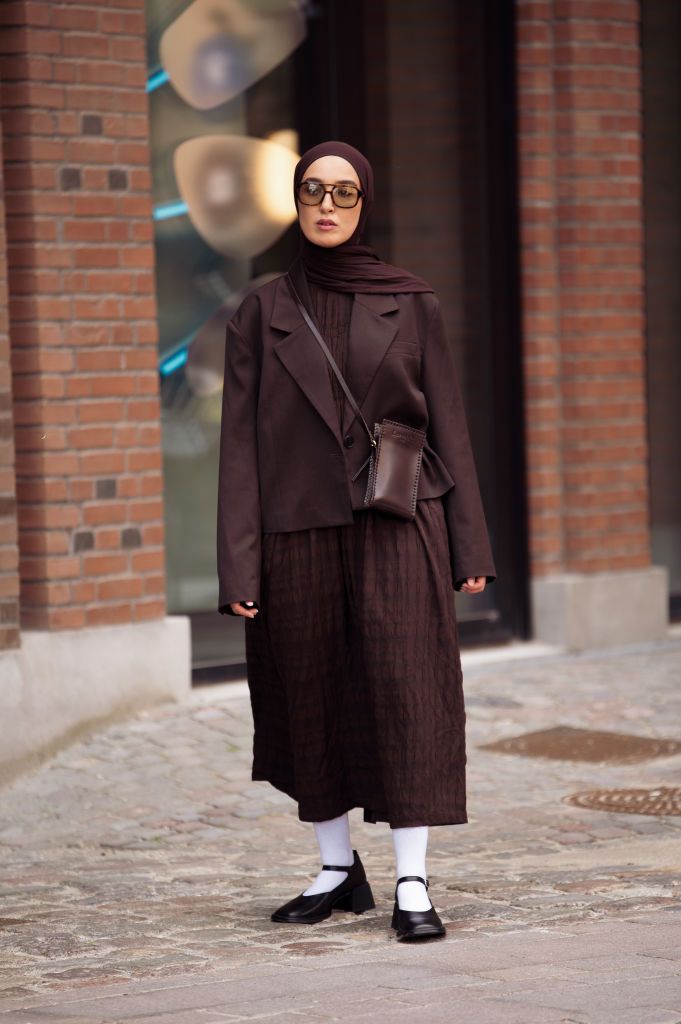 a guest at copenhagen fashion week wears an all brown outfit to illustrate a guide to fall outfit ideas for 2023