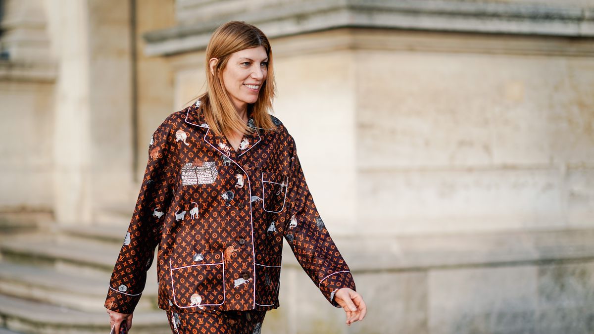 A guest wears a Vuitton brown monogram pyjama outfit, outside