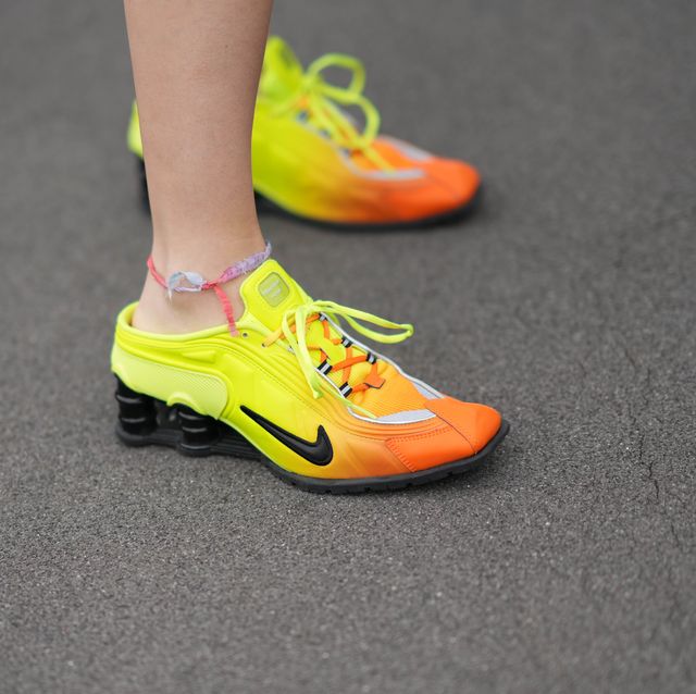 https://hips.hearstapps.com/hmg-prod/images/guest-wears-an-anklet-orange-and-yellow-nike-sneakers-news-photo-1696959758.jpg?crop=0.669xw:1.00xh;0.167xw,0&resize=640:*