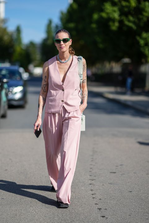 a woman wearing a pink vest and trousers during copenhagen fashion week in a roundup of cute summer outfits 2023