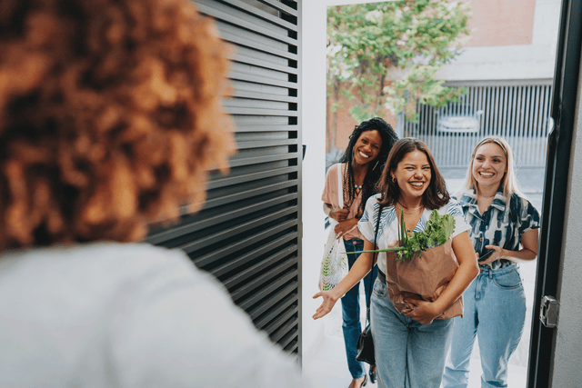 a group of women standing outside a building