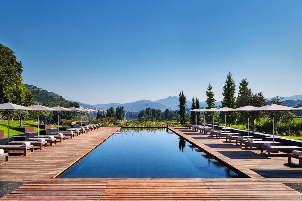 Mountain range, Swimming pool, Hill station, Resort, Reflection, Outdoor furniture, Shade, Resort town, Alps, Sunlounger, 
