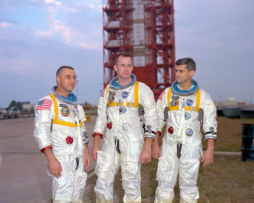 Gus Grissom, Ed White and Roger Chaffee pose in front of their Saturn 1 launch vehicle at Launch Complex 34 at the Kennedy Space Centre, Florida