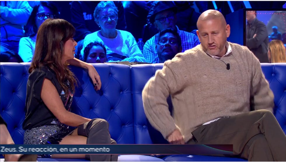 a man sitting on a bench with a woman standing behind him