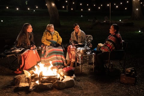 chelsea clinton, hillary clinton, quannah chasinghorse, and jodi potts sitting around a fire