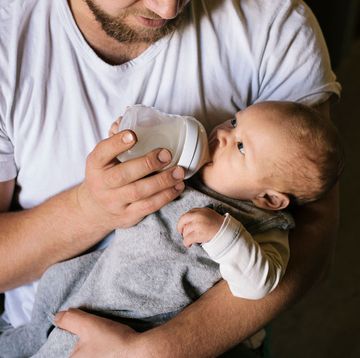guy bottle feeding a baby