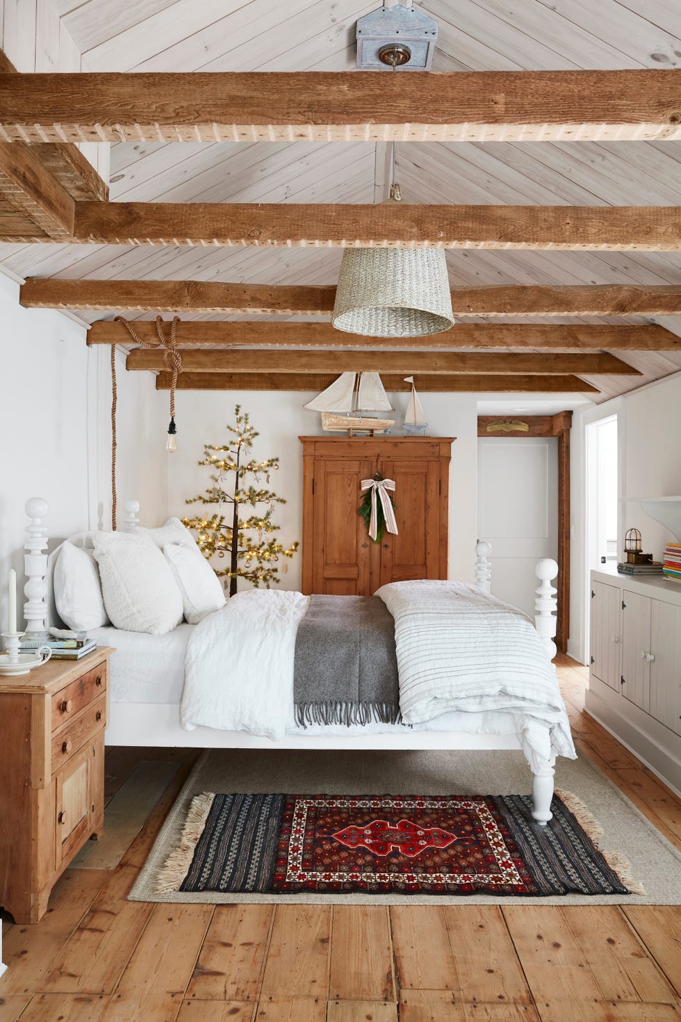 rustic white bedroom with raw ceiling beams