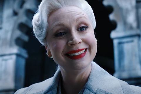 woman with white hair and red lipstick smiling