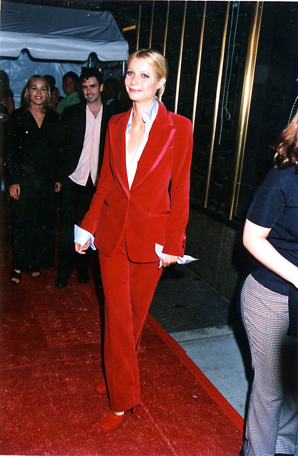 Gwyneth Paltrow wearing a red suit walking on a red carpet