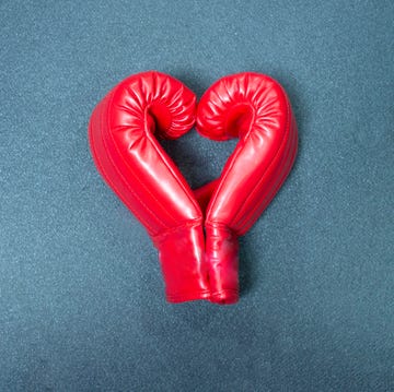 gym background and fitness equipment and valentine concept boxing glove in shape of heart