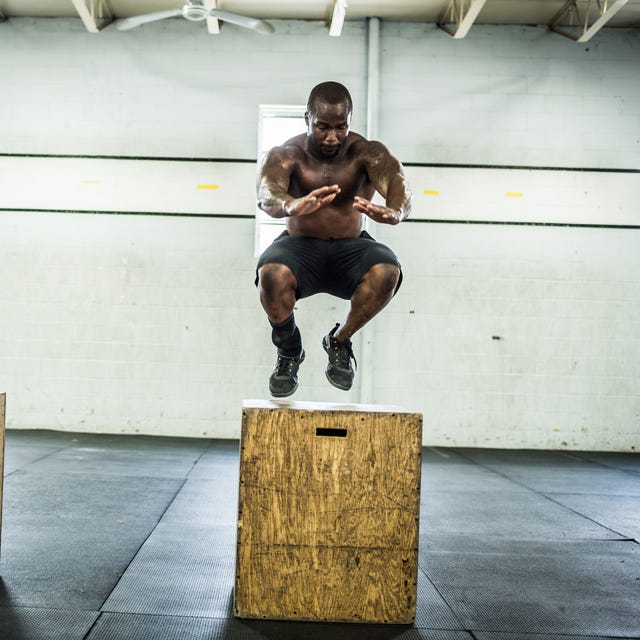 gym man doing box jumps