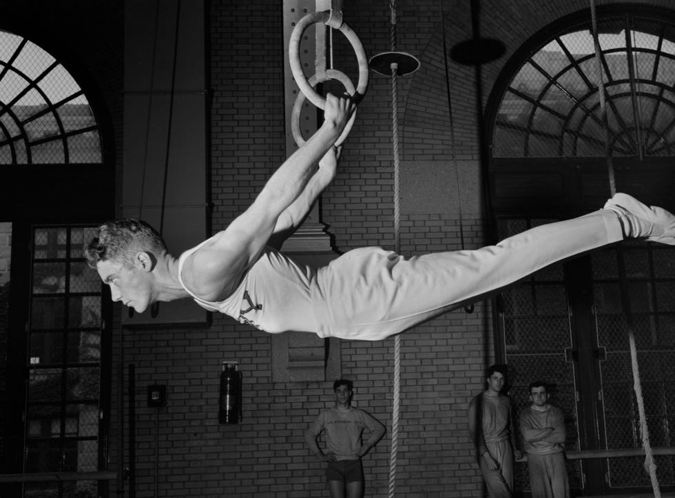 gymnast on still rings, us naval academy, annapolis, maryland, july 1942