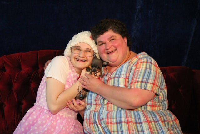 gypsy rose blanchard and her mother dee dee holding a dog together and smiling