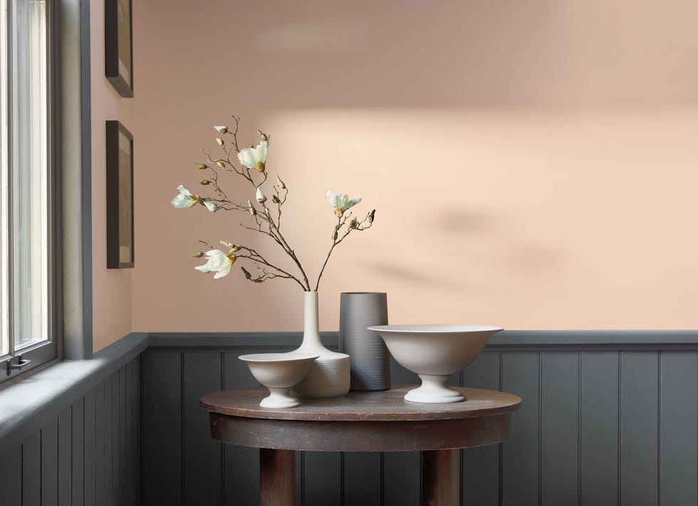 a set of vases and pottery against a background that is painted beige