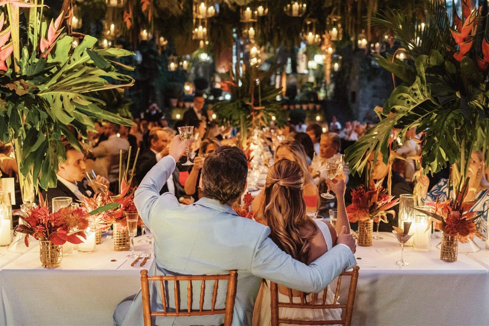 celebration dinner with guests toasting at a beautifully decorated table