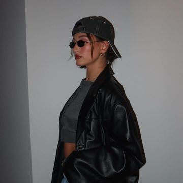 a person wearing a leather jacket and sunglasses
