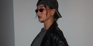 a person wearing a leather jacket and sunglasses
