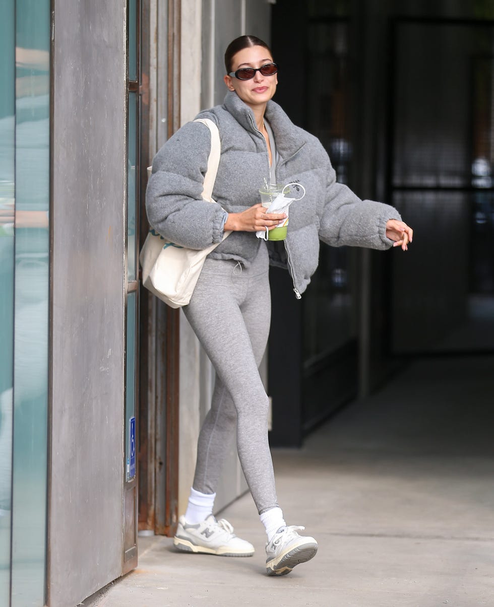 hailey bieber wearing new balance 550 sneakers grey leggings puffer jacket casual outfit celebrity street style