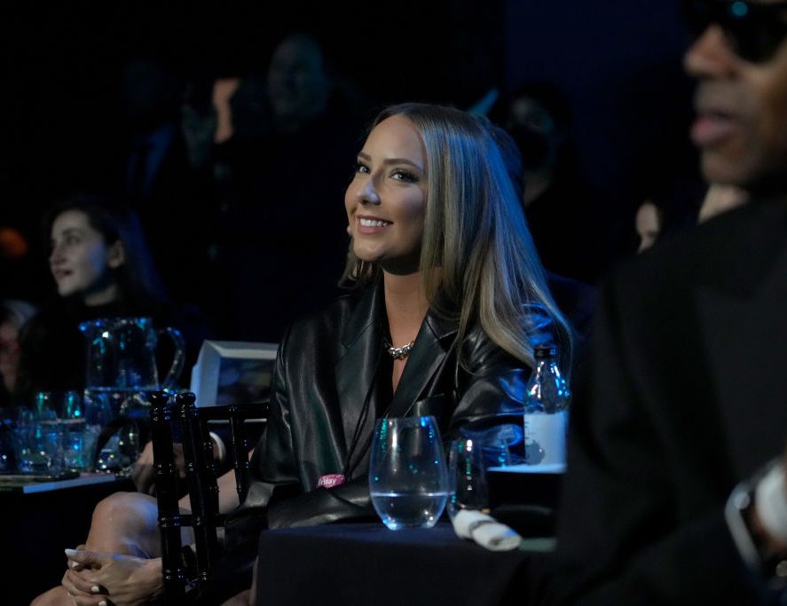 eminem's daughter hailie jade smiling as she sits at a table