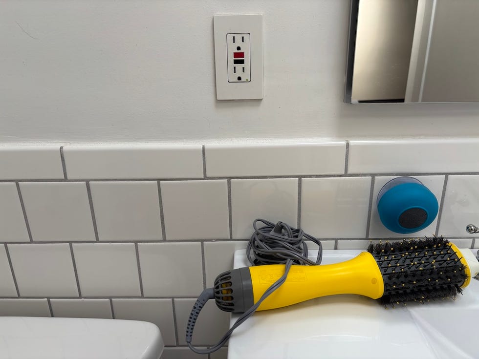 hair tool and bathroom accessories on a countertop