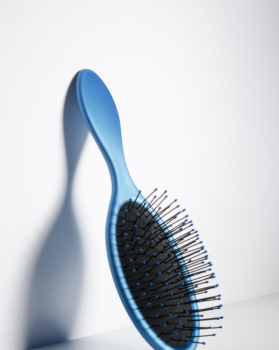 hairbrush leaning against wall