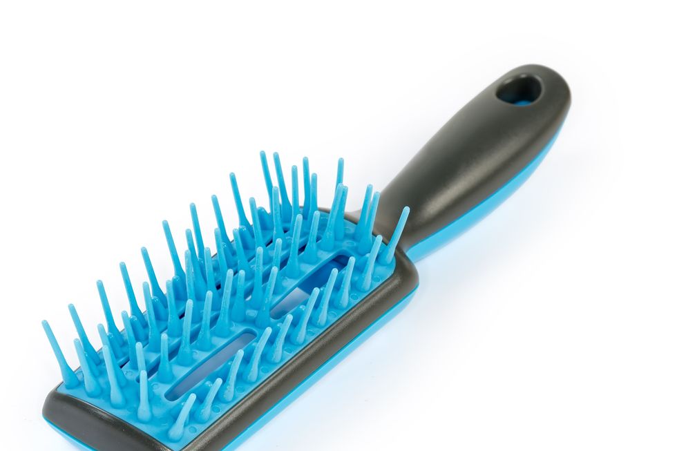 hairbrush with plastic bristles on a white background