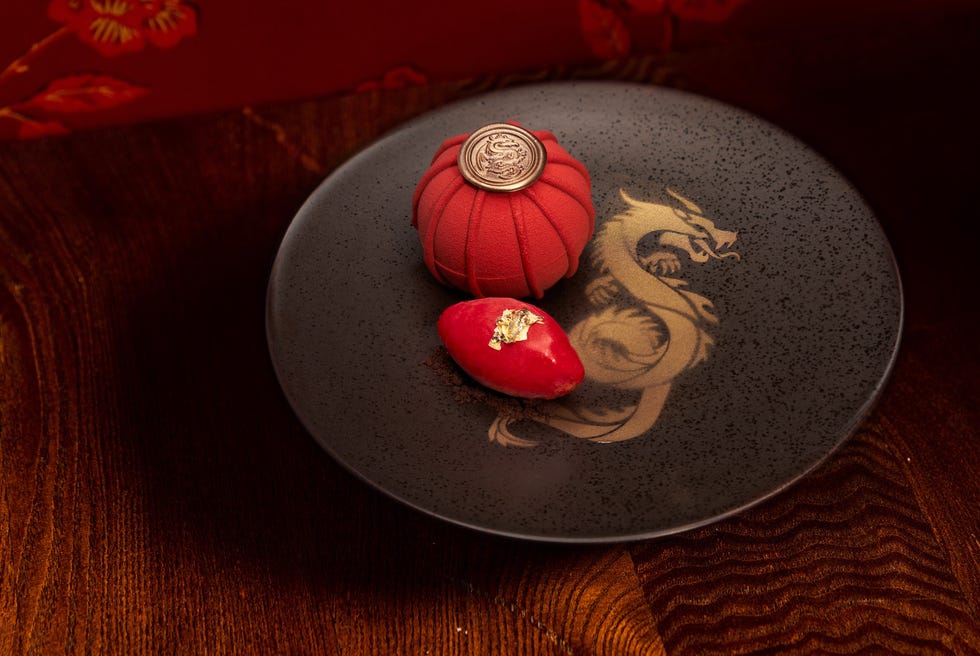 a plate with a couple of red and white objects on it a plate with a couple of red and white objects on it