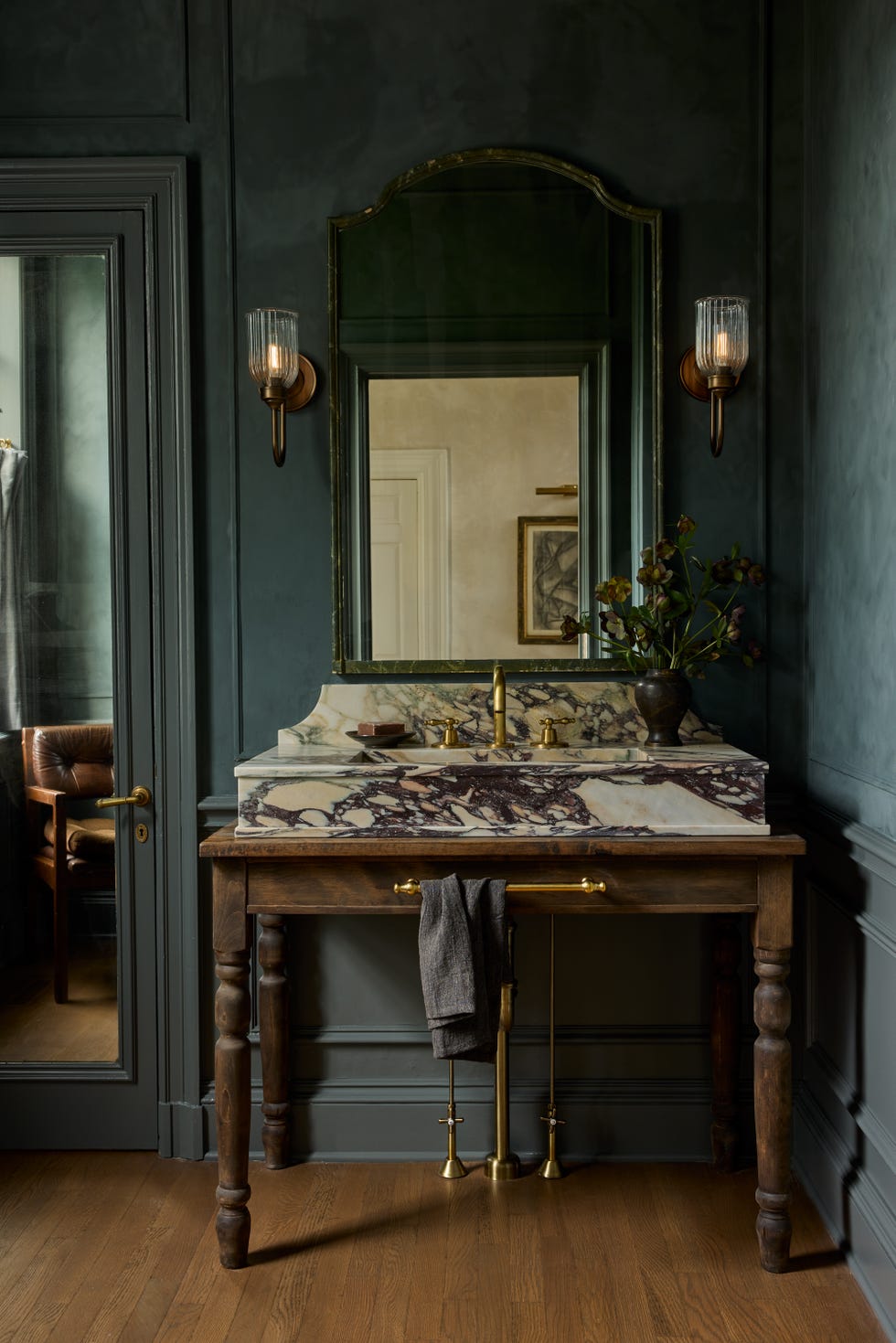 bathroom with marble vanity and dark blue walls