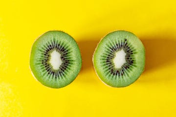 half kiwi pieces on yellow background