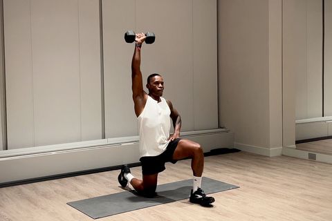 shoulder and arm workout,yusuf jeffers practicing half kneeling single arm arnold press exercise