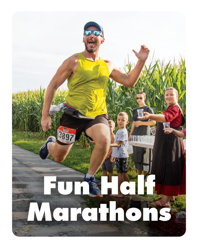 runner participating in a half marathon with volunteers offering drinks