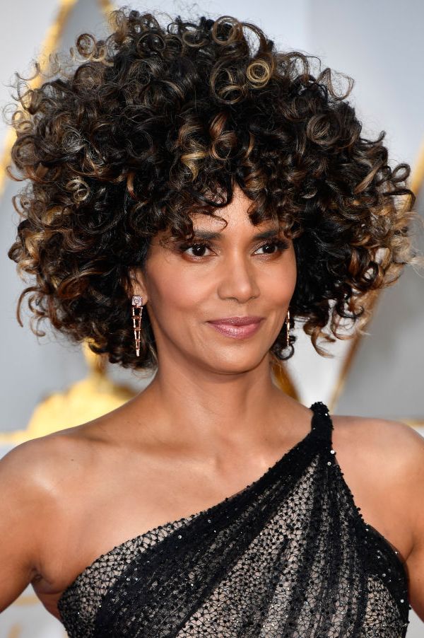 halle berry's curly, black hair is a major wedding guest hairstyle inspiration and looks exceptional with her black gown and neutral makeup