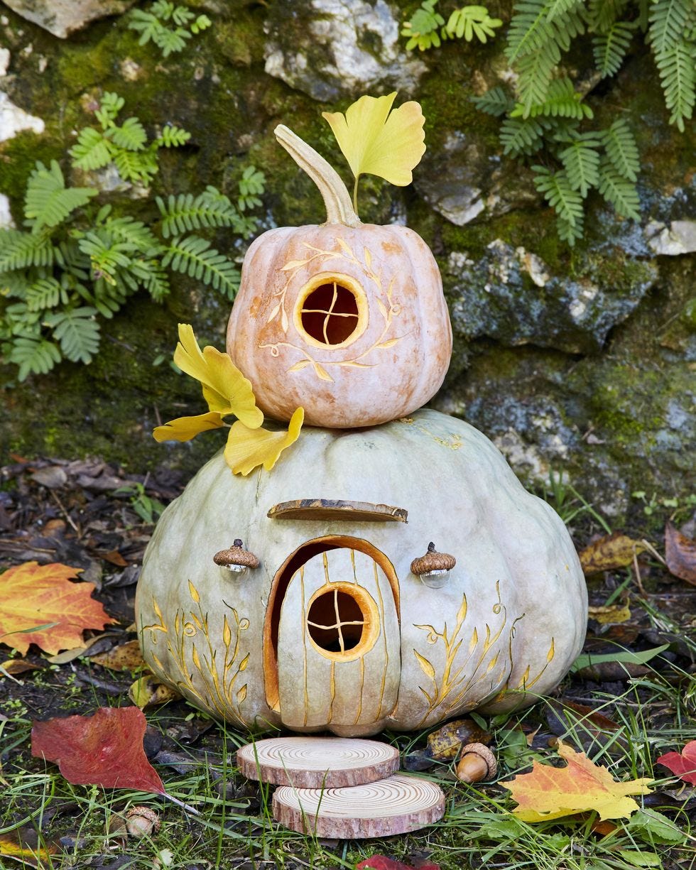 two story pumpkin fairy house decorated with gingko leaves that adults and kids can make together for a halloween activity