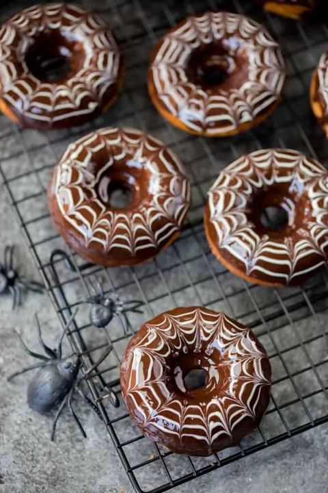 halloween spider doughnuts on wire rack with fake spiders
