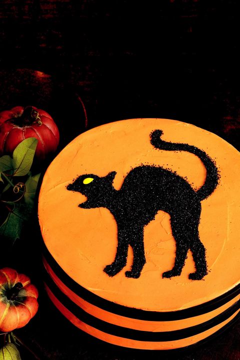 orange layer cake with black cat stencil on top