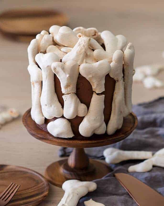 meringue bone cake on wood cake stand