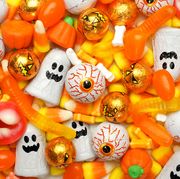halloween candy background with worms, eyeballs and ghosts