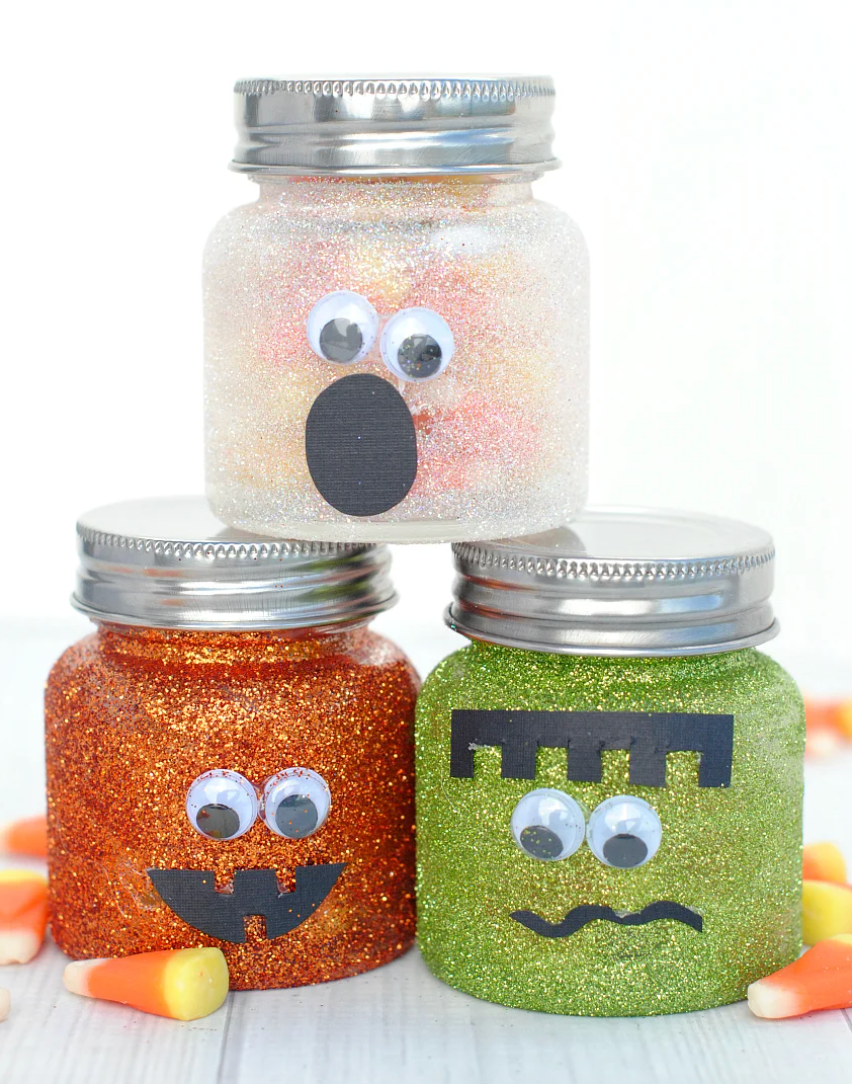 a couple of jars with halloween faces