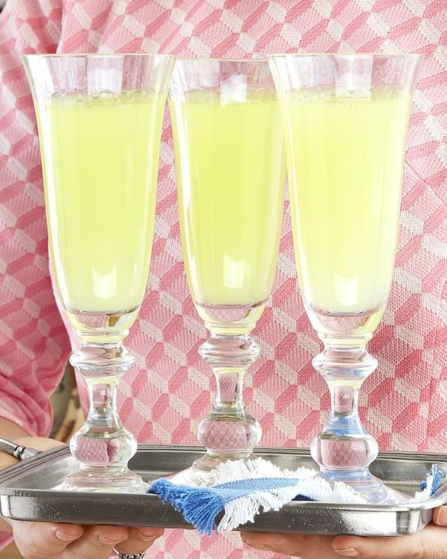 three death in the afternoon cocktails in champagne flutes on a serving tray